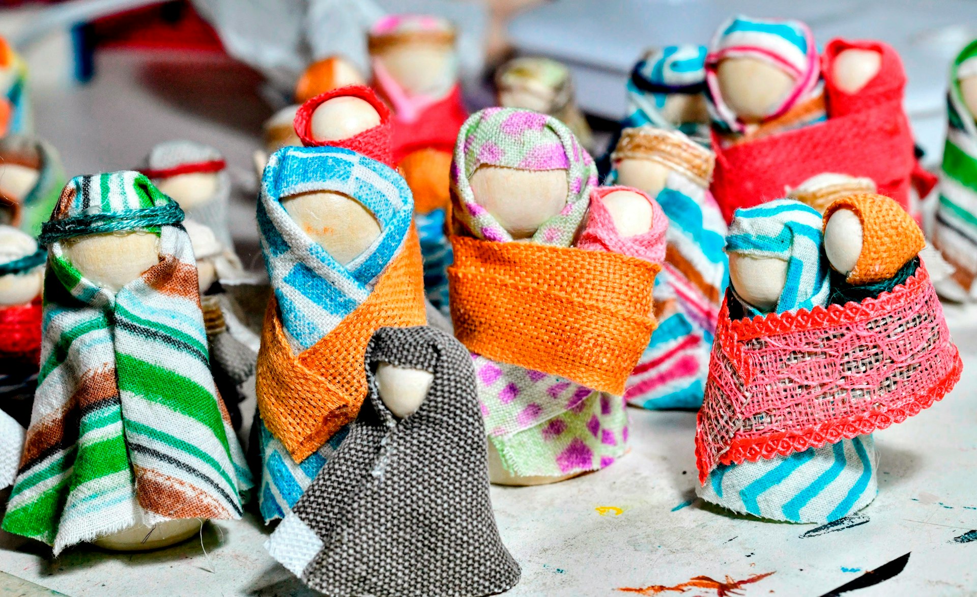 a group of cloth dolls sitting on top of a table